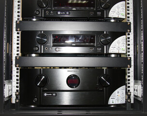 A telecommunications rack with multimedia and network electronic equipment.