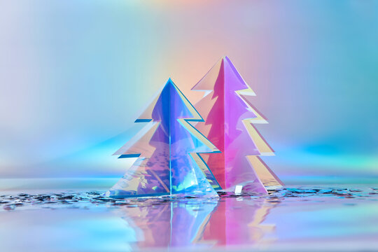 Christmas trees made of iridescent plastic with confetti in studio
