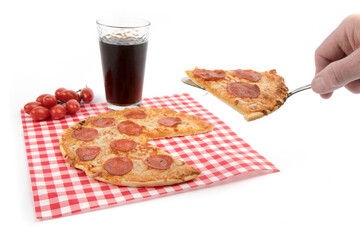 a pizza spatula holding a slice of pepperoni pizza with a glass of cola  isolated on white