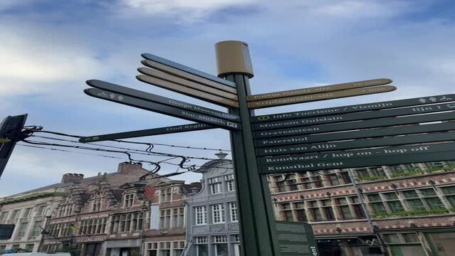 looking at the tourism road sign in Ghent, Belgium