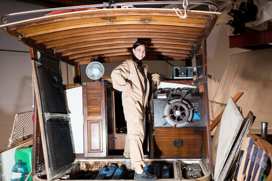 Proud female mechanic during boat restoration process