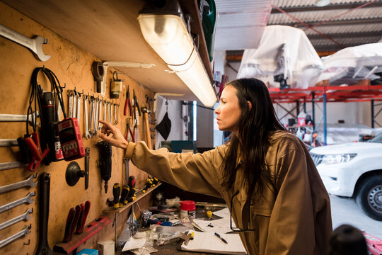 Female mechanic working at nautical workshop