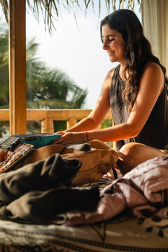Woman with phone at her topical vacation hotel room