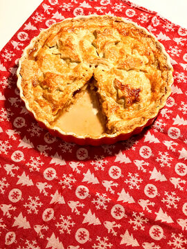 Christmas themed apple pie on a red tablecloth