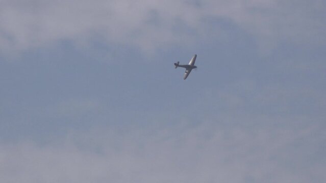 Vintage military airplanes spitfire hawker hurricane in Battle of Britain reenactment flying low in display.
