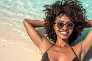 top view of Young African american Woman Relaxing on the Beach with Sunglasses