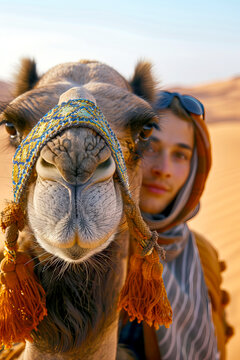 vertical image of Traveler in Traditional Attire with Camel in the Desert dunes