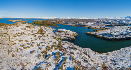 Autumn in Iceland; landscape with lake myvatn covered with a thin layer of freshly fallen snow