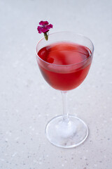 Red alcoholic cocktail with flower