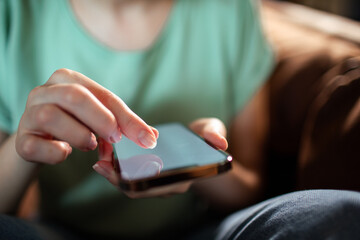 Top view of woman holding smartphone with blank screen
