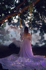 magical photo. girl on a swing in a white dress