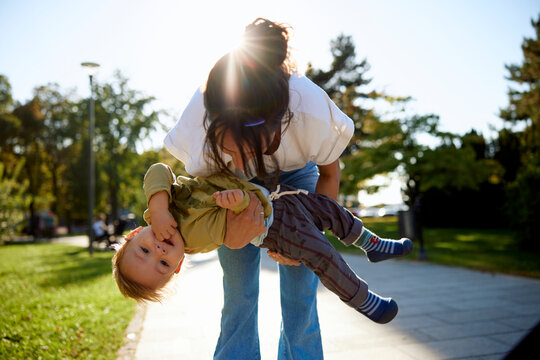 Portrait of a mother entertaining her son in the park