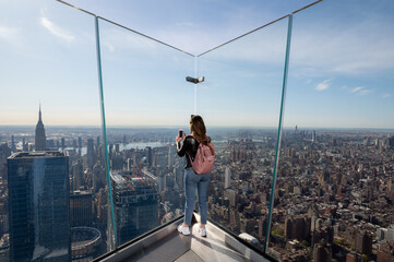 Woman photographing Manhattan from observatory
