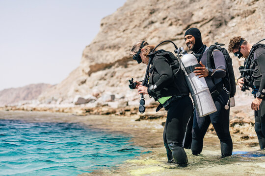Scuba Diveing couple entering water