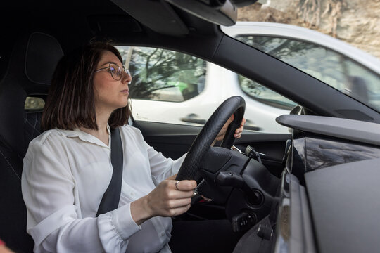 young pregnant italian woman driving her car