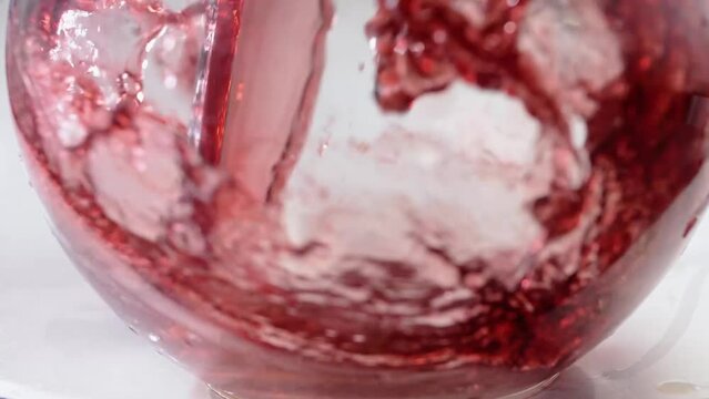 Splash and wave of red wine or berry juice 