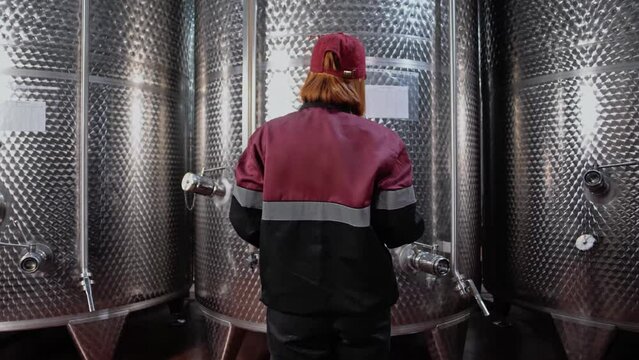 Chemical engineer motions to the huge wine tanks