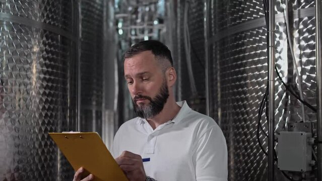  Technologist with beard on wine product plant