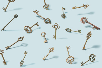 Variety of vintage ornate keys scattered on light blue background
