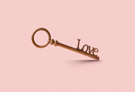 Vintage bronze key with word Love on clipping path in studio