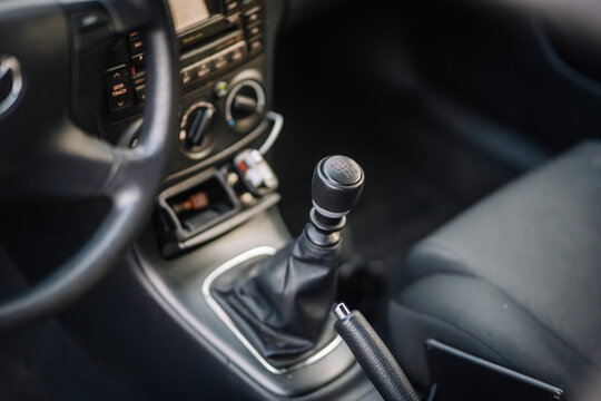 Valmiera, Latvia - March 17, 2024 - A close-up view of a car’s gear shift, handbrake, and part of the center console with air conditioning controls.