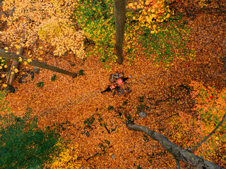 Couple of cyclists posing on the fallen leaves in an autumn forrest