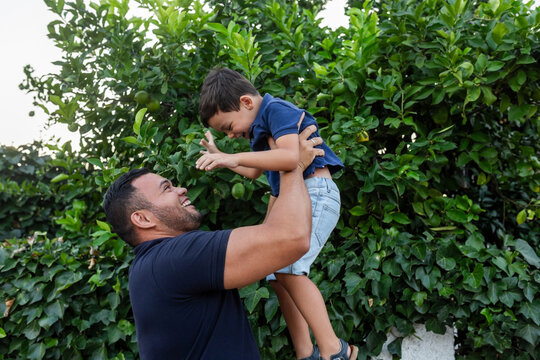 latin father with little son playing outdoors