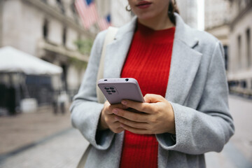 Close-up of an unrecognizable woman using a smartphone outdoors
