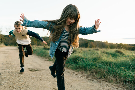 little kids pretending to be flying 