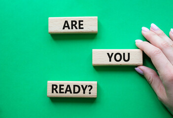 Are you ready symbol. Concept word Are you ready on wooden blocks. Businessman hand. Beautiful green background. Business and Are you ready concept. Copy space