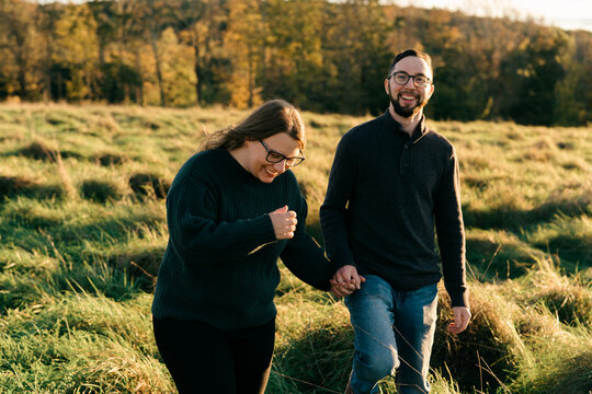 young couple walking on a dirt path in the evning