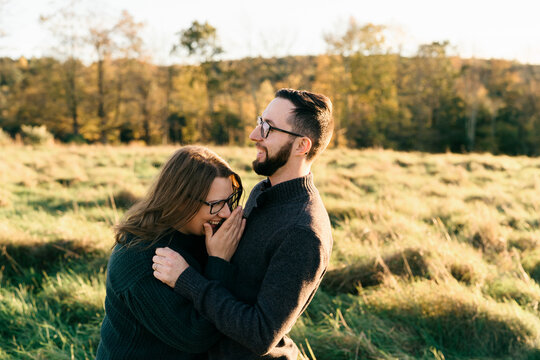 young couple walking on a dirt path in the evning
