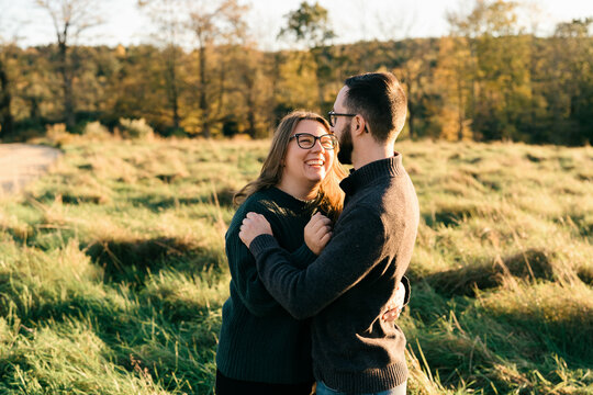 young couple walking on a dirt path in the evning