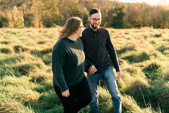 young couple walking on a dirt path in the evning