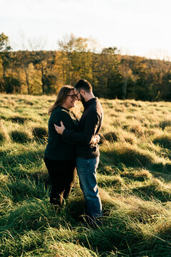young couple walking on a dirt path in the evning