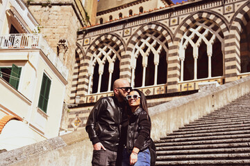  Happy smiling beautiful  Tourists  couple traveling in Italy poses and making photos near the...