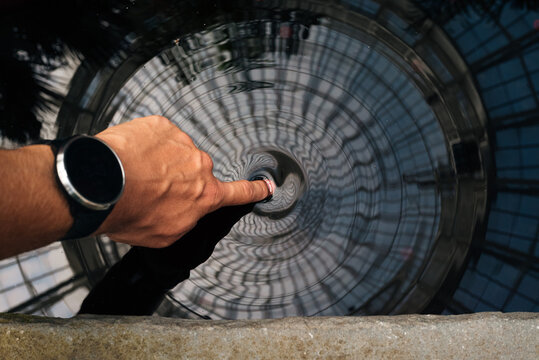 man touching water with one finger