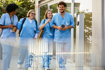 Smiling healthcare workers with takeaway coffee taking a break
