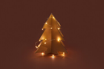 Cardboard Christmas tree with glowing garland lights