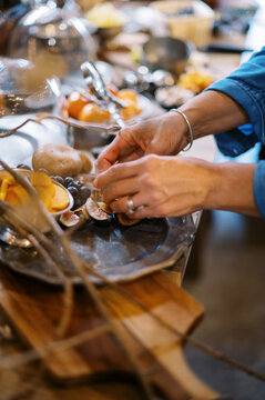 chef placing fresh figs on a pewter platter on an apperizer table