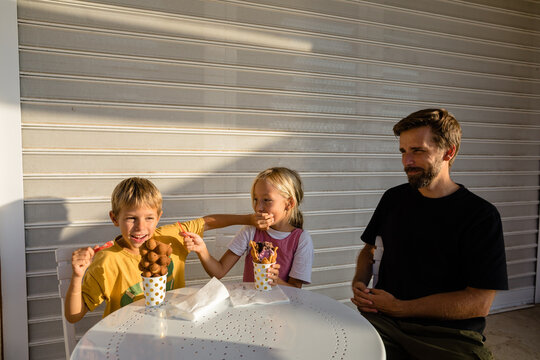 Kids fooling around and eating ice cream