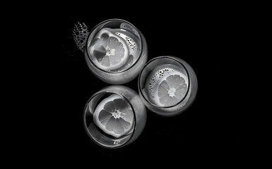 Glasses of orange juice on black background with copy space