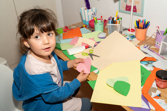 Messy craft kid. Little girl doing art crafts 