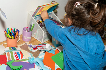 Messy craft kid. Little girl doing art crafts 