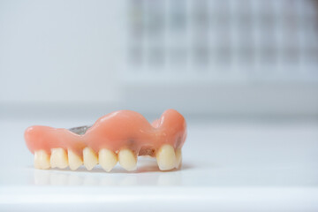 detail of a denture on the white table in a dental laboratory - obrazy, fototapety, plakaty