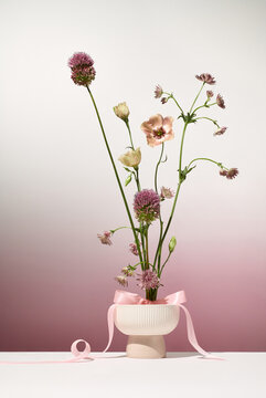 small bouquet of pink flowers on a garden pink background