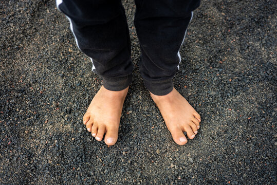 Close-up of the bare feet of an anonymous teenager