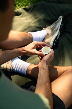 Hands of the person as they hold the cannabidiol ointment