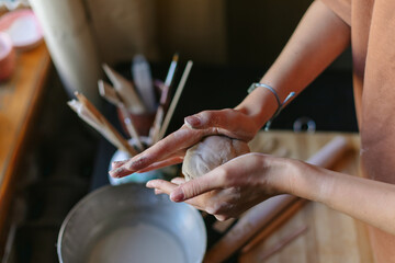 hands of a master potter who works with clay