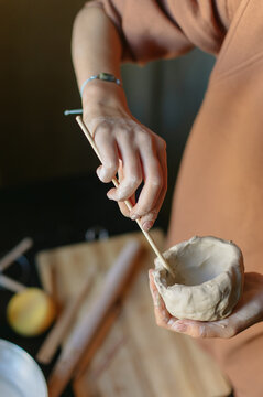 hands of a pottery master with a product